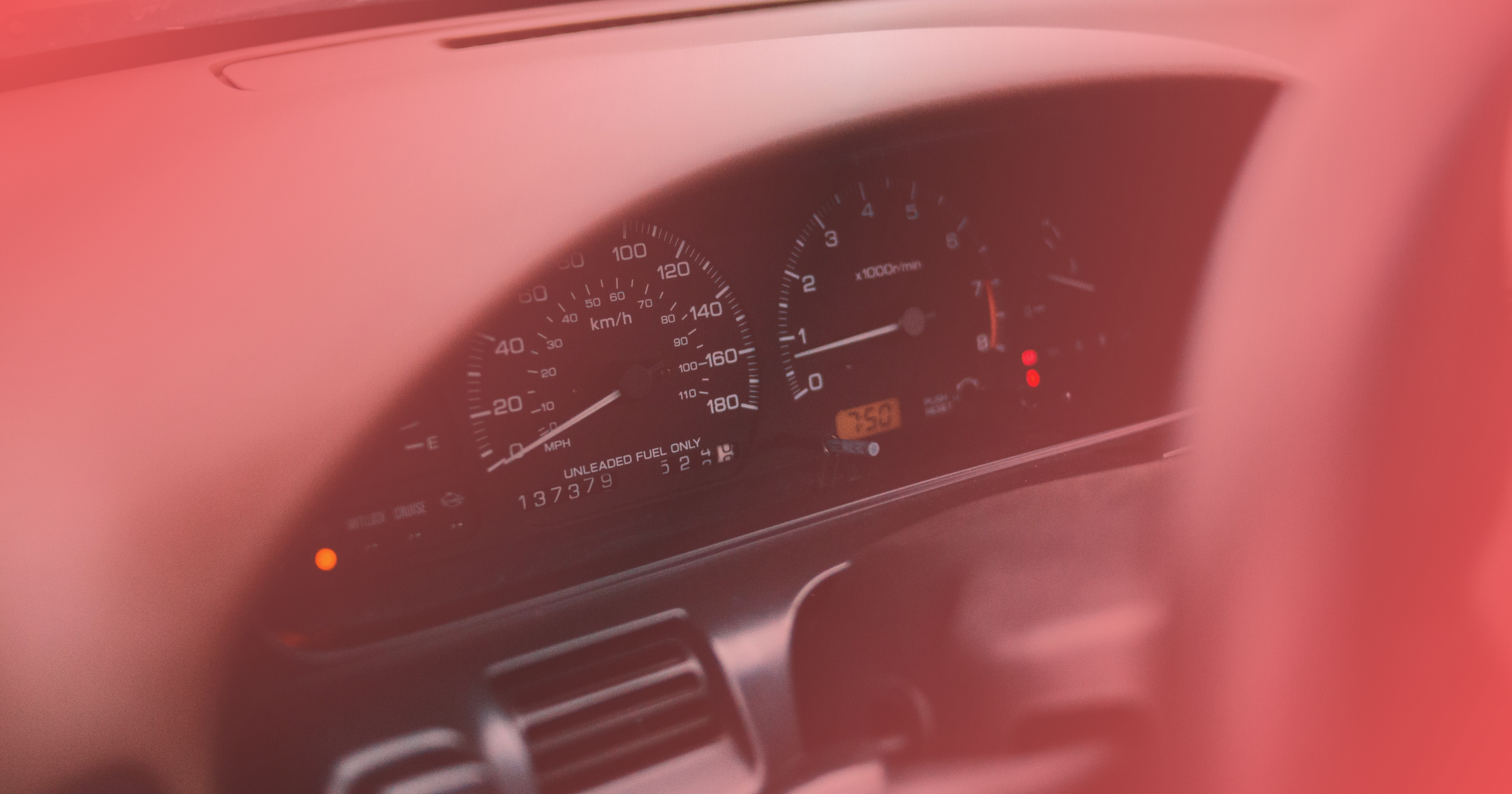 Tracking business mileage: Close-up of a car dashboard with speedometer and tachometer.