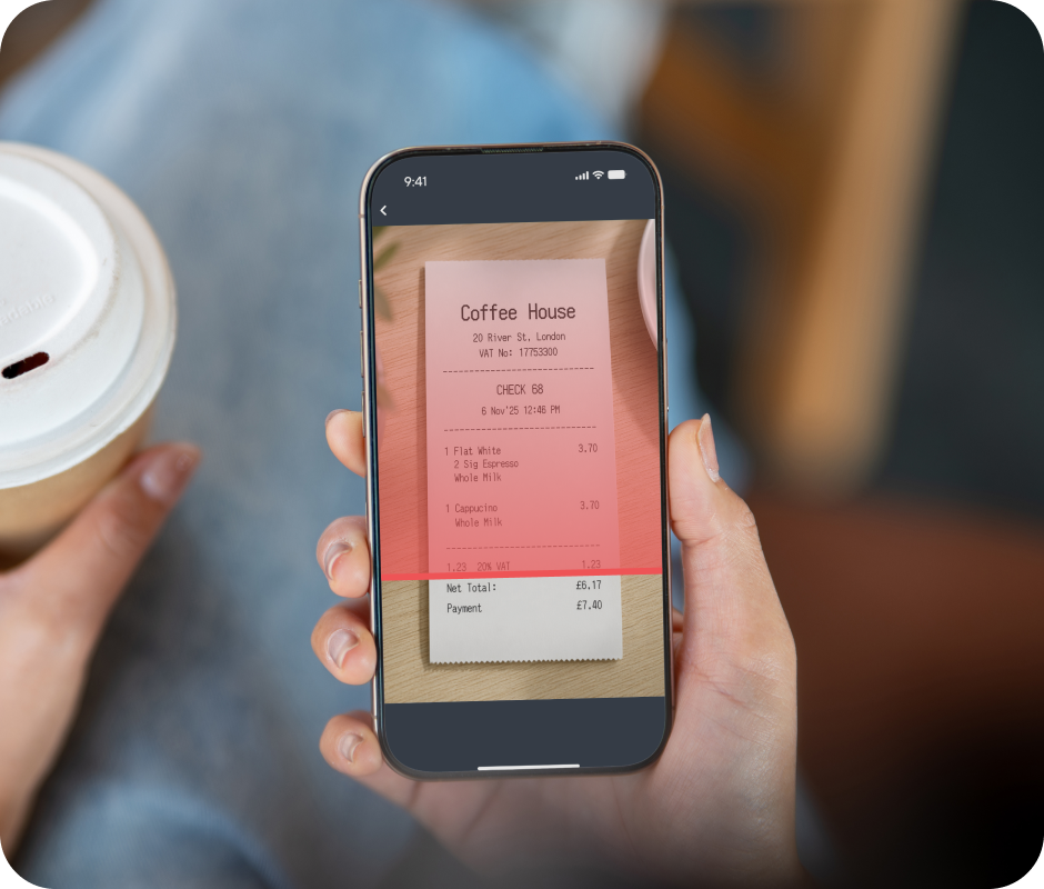Person holding a smartphone displaying a coffee shop receipt, accompanied by a cup of coffee in the other hand.