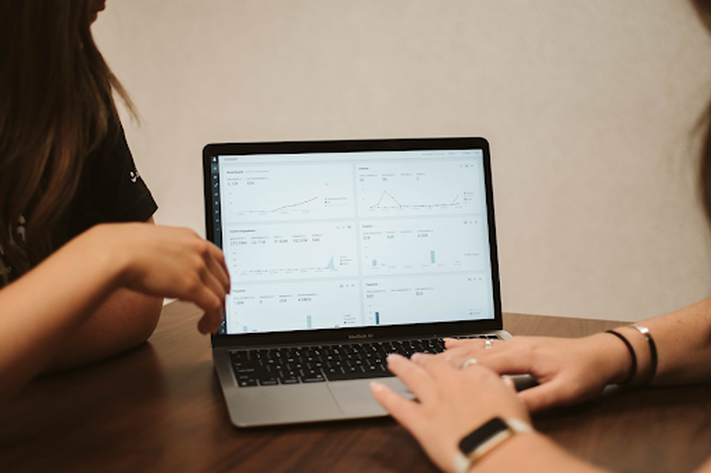 two women looking at a marketing report