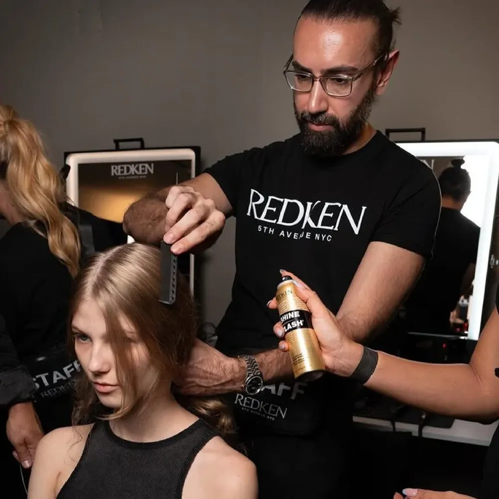 A picture of Redken stylist and a model, portraying the brand's collaboration with public figure