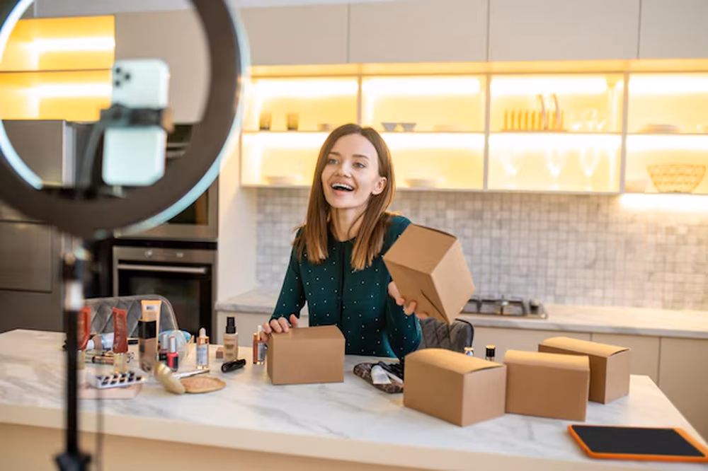 An illustration of influencer recording package unboxing video from a brand