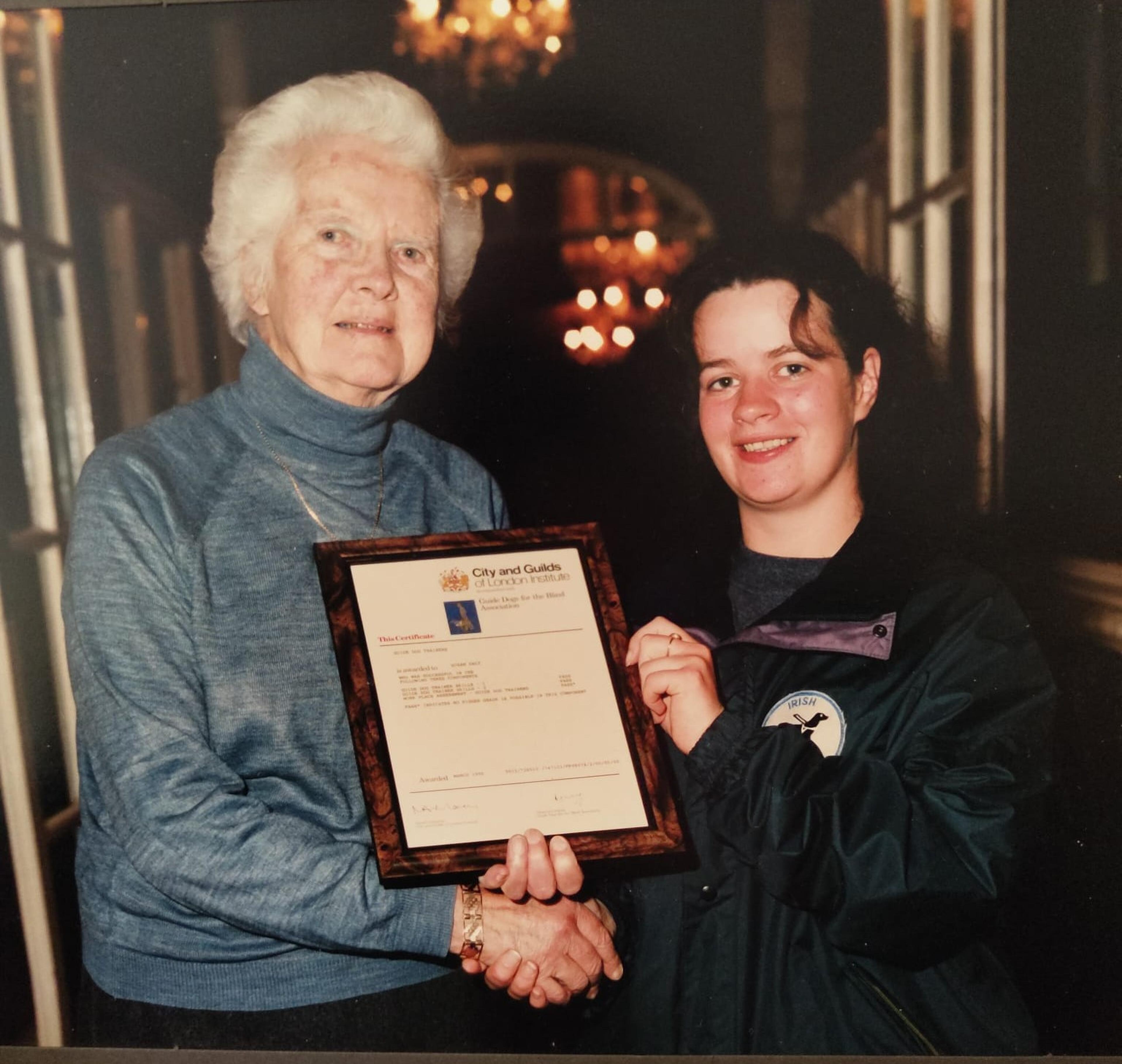 Mary presenting Susan with her training certificate