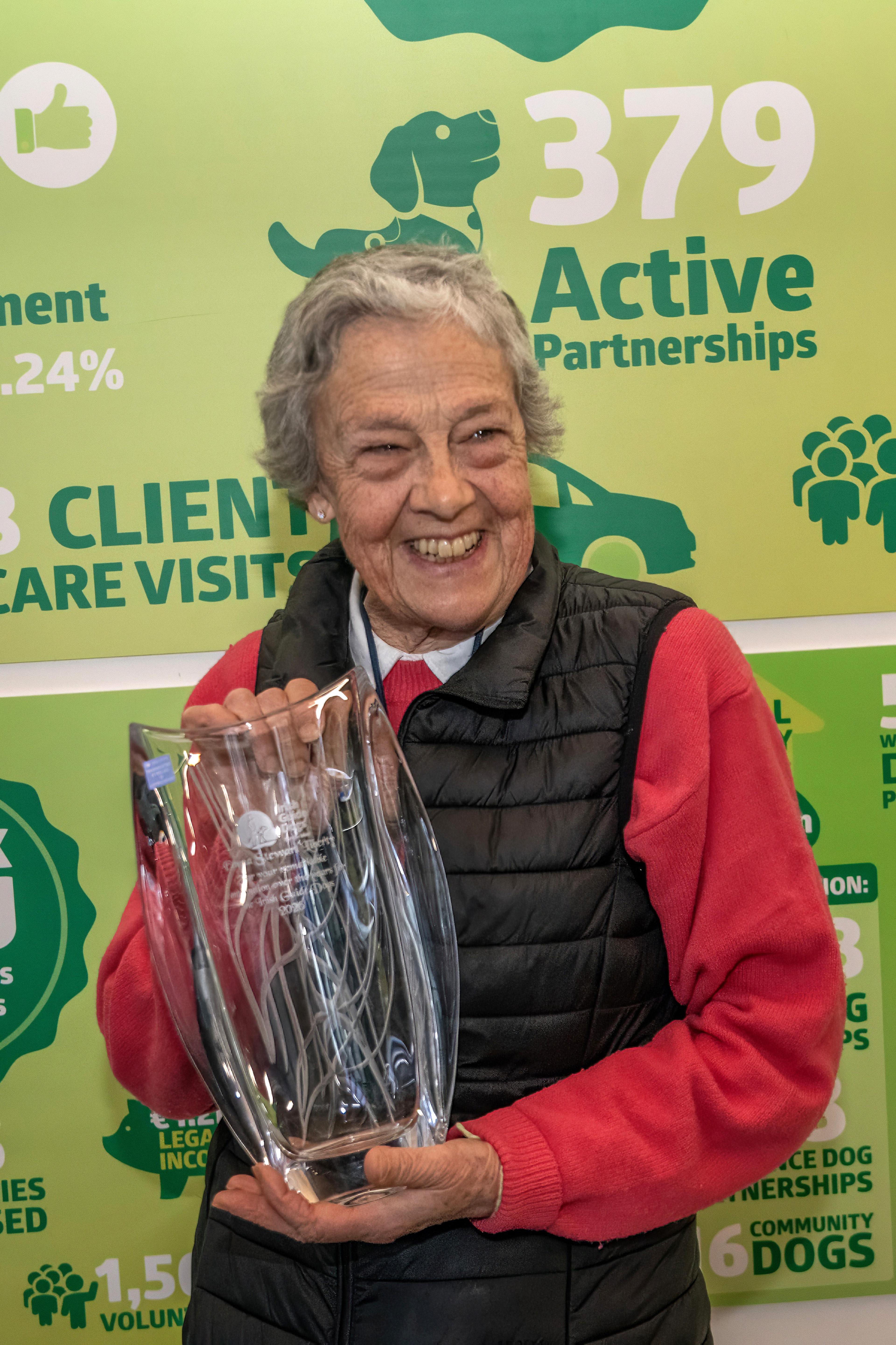 Emma smiling holding her glass vase