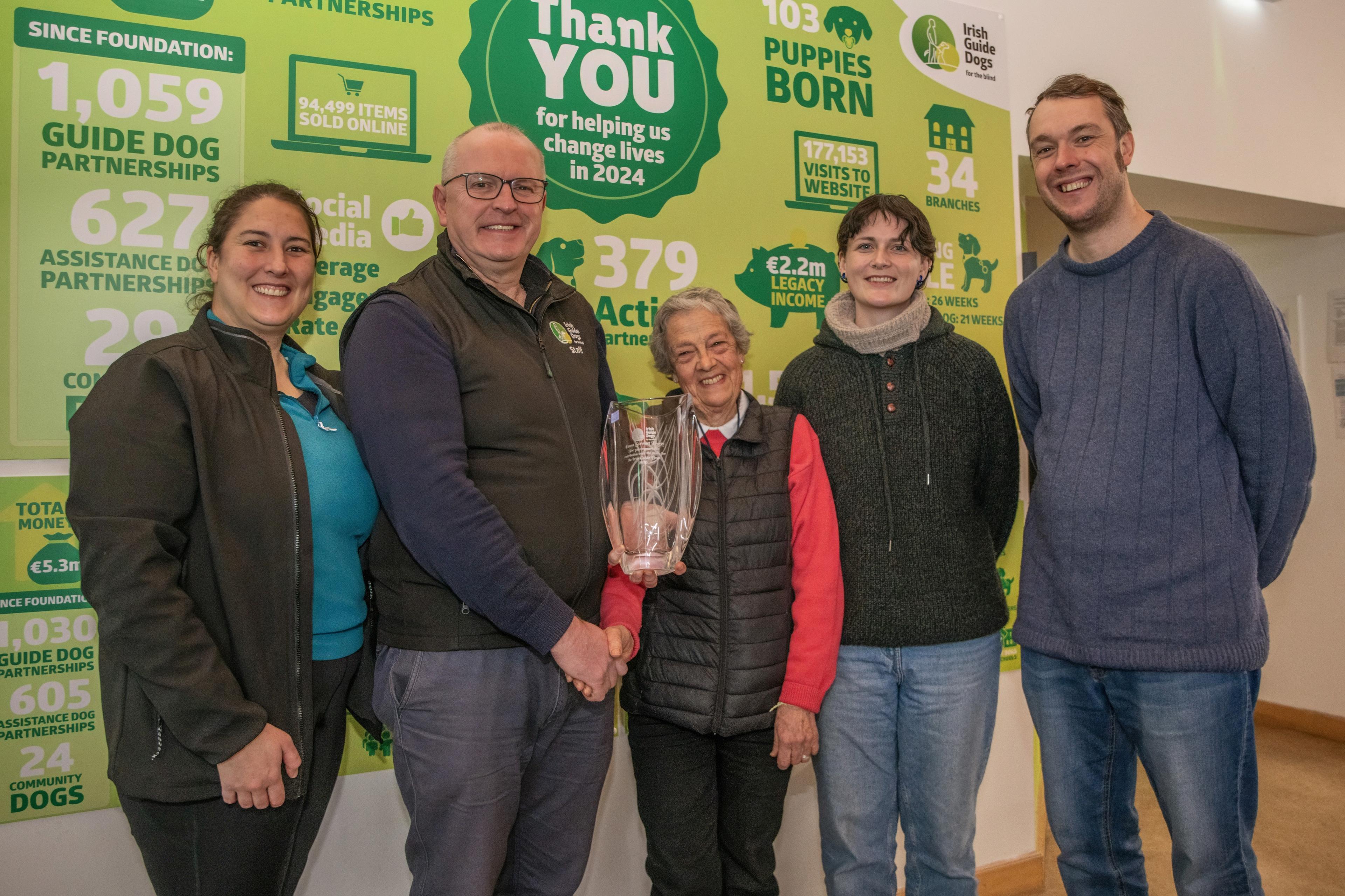 Emma pictured with Dog Breeding Manager Ruth Armstrong, CEO Tim O'Mahony, and Fundraising Lead Chris Bennett