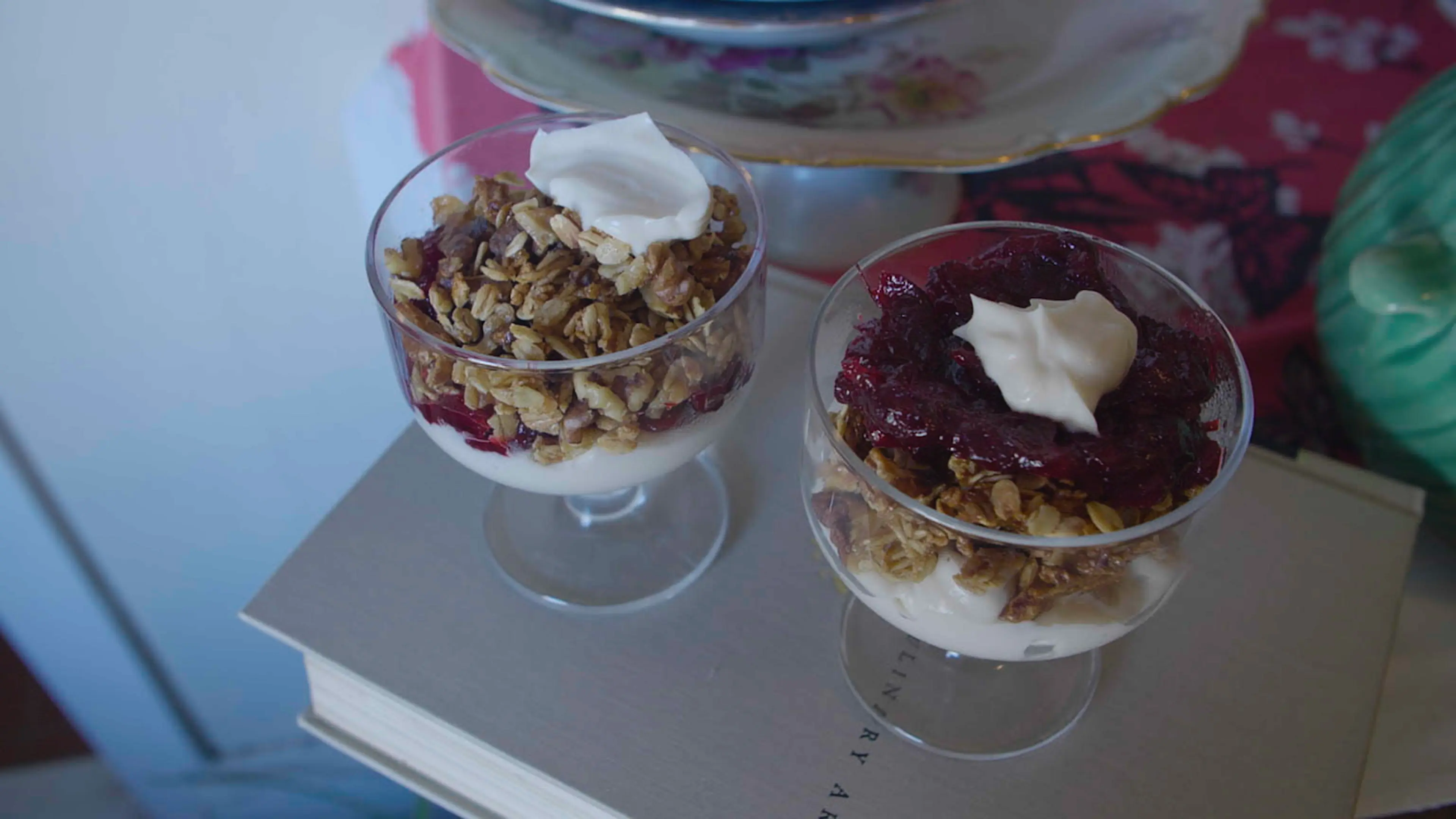 Two parfaits in glasses on top of a book.
