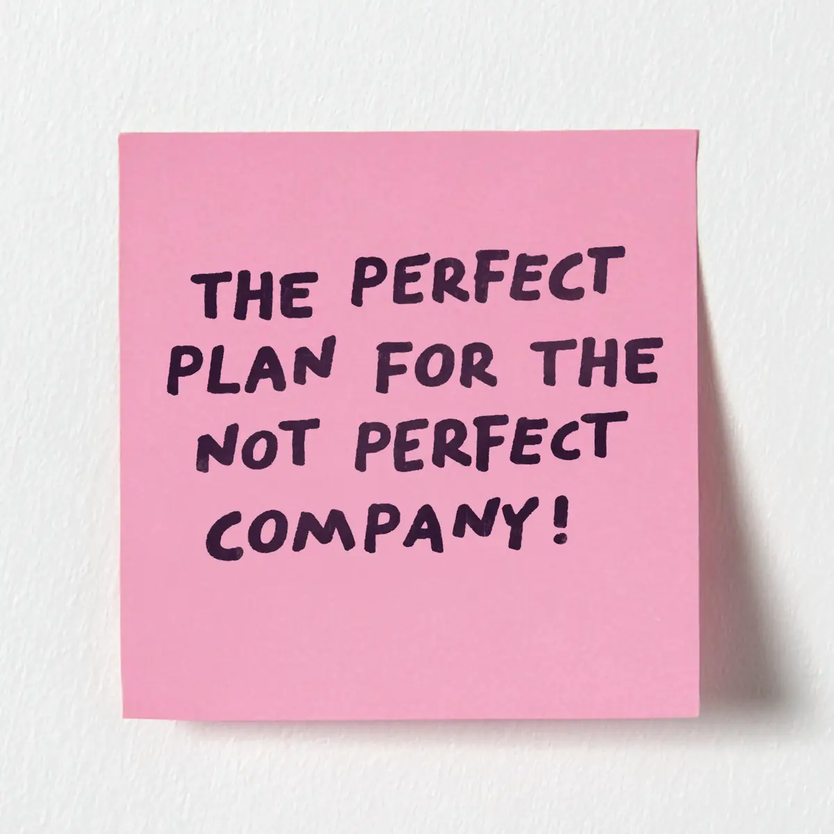Pink sticky note with handwritten text: "THE PERFECT PLAN FOR THE NOT PERFECT COMPANY!" on a white background.