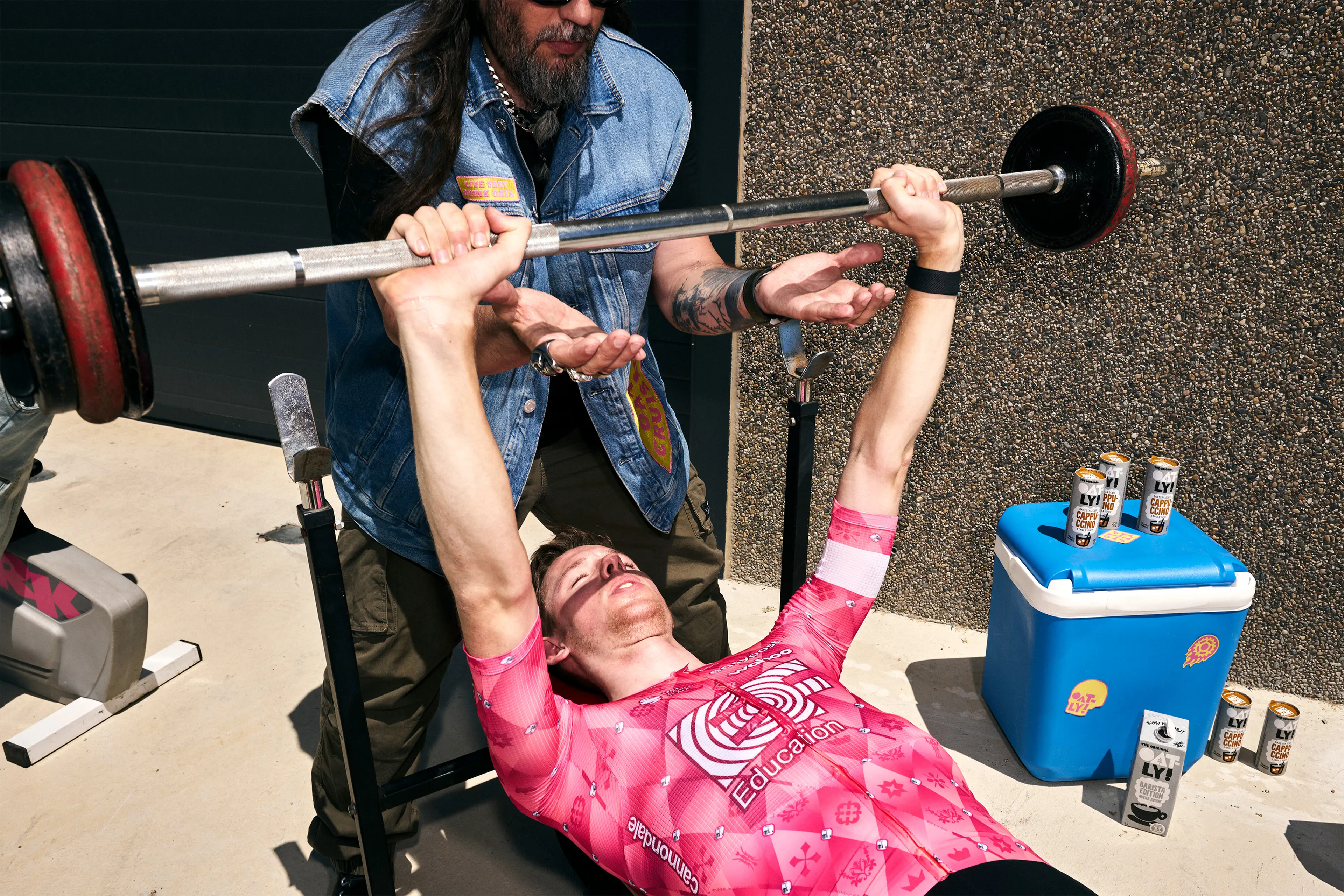 EF Pro Bikers spotting each other while doing a bench press