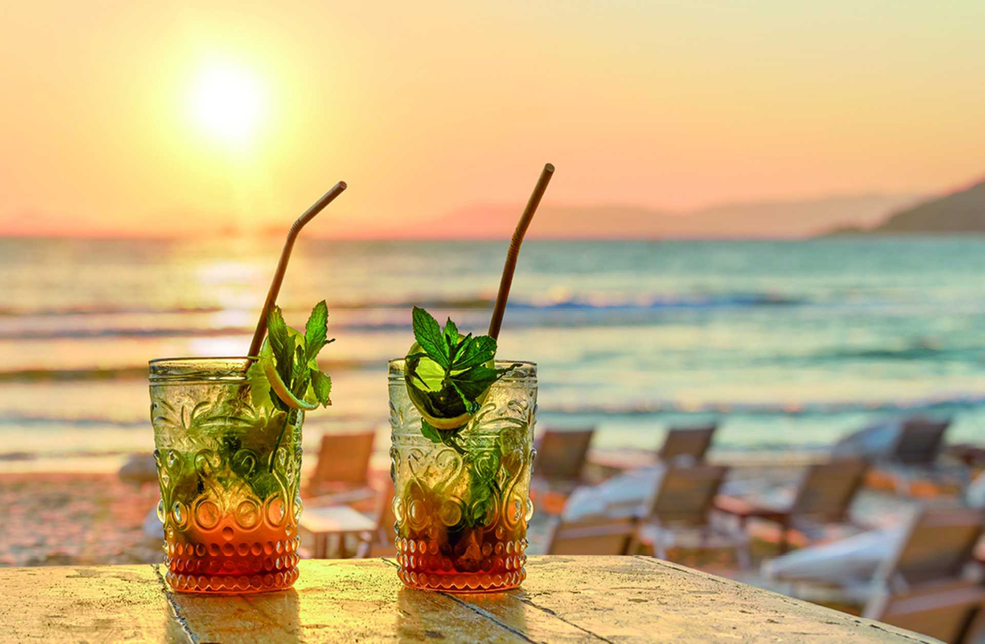 drinks with blur beach and sunset in background