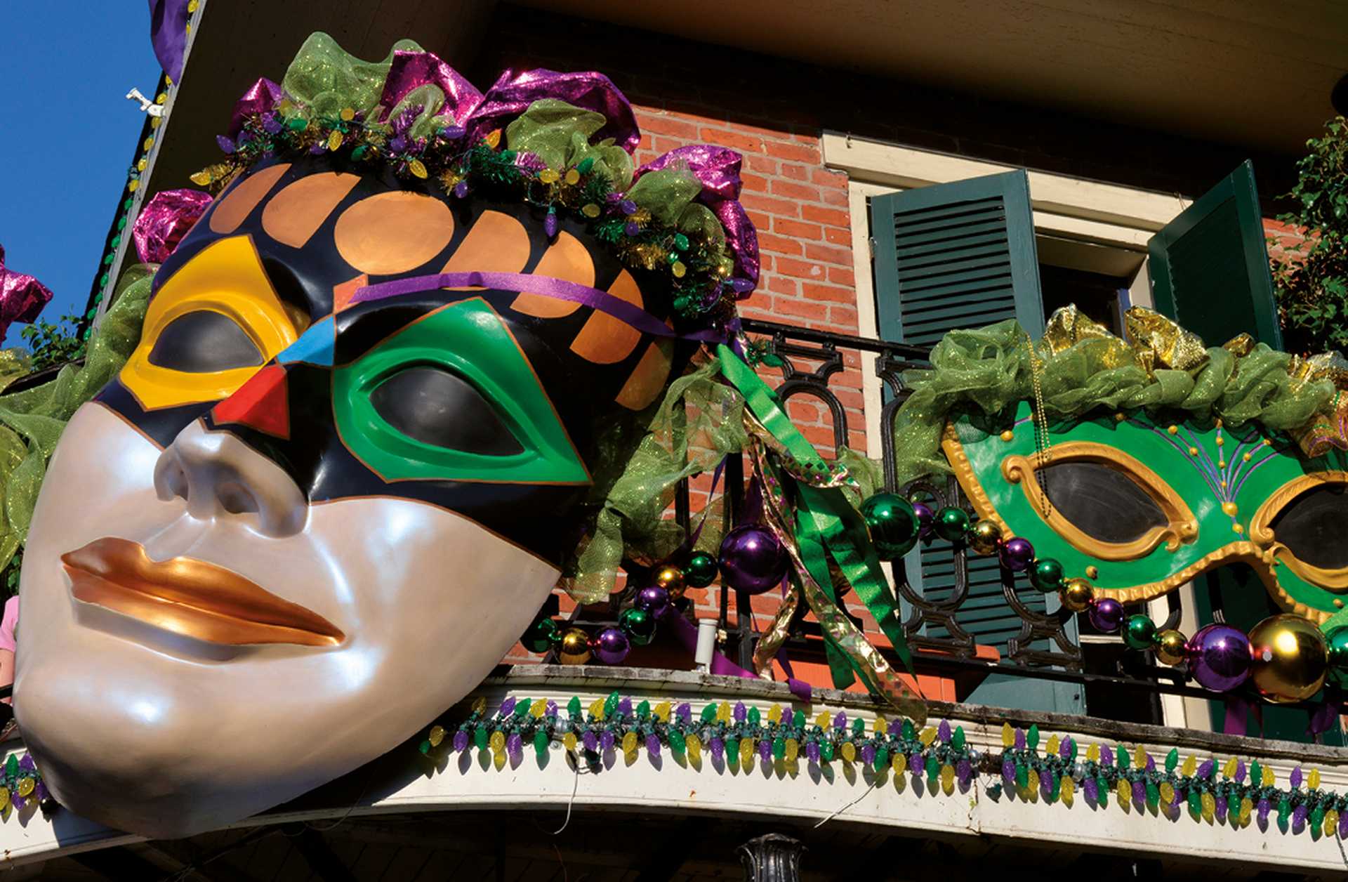 Giant masks as Mardi Gras balcony decorations in New Orleans