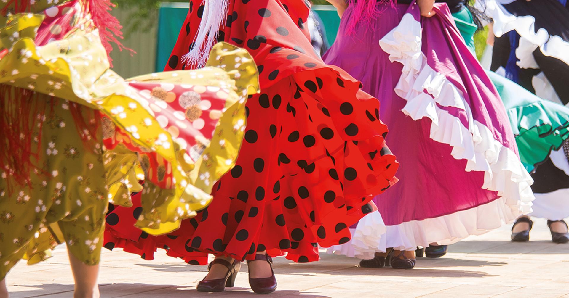 Feet of flamenco dancers, performing on a wooden stage in summer city festival