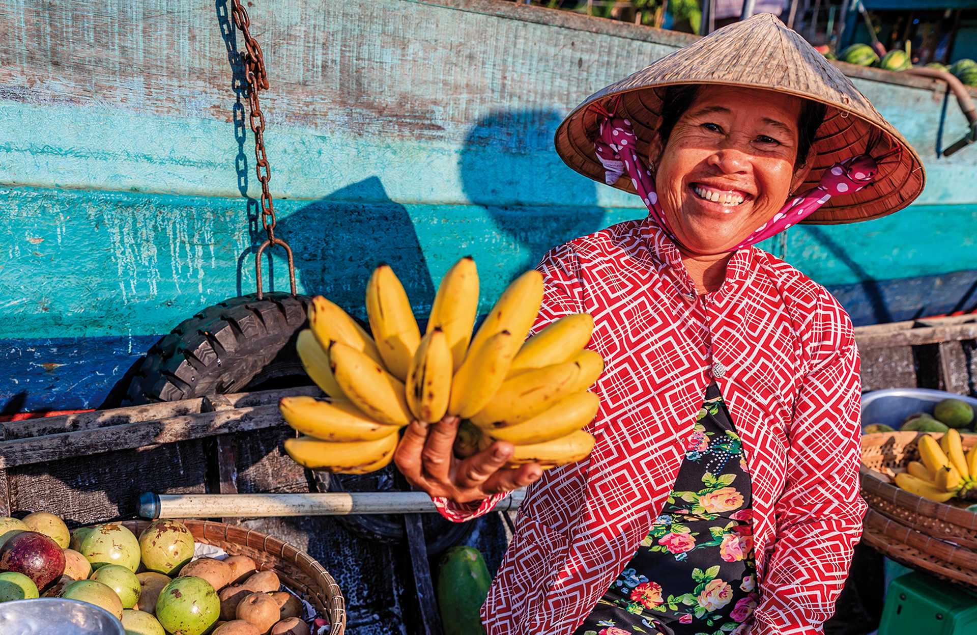 Vietnamese woman selling bananas on floating market, Mekong River Delta, Vietnam