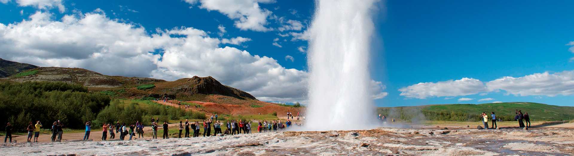 Impressive eruption of the biggest active geysir, Strokkur, with tourists waiting around, Golden circle, Iceland
