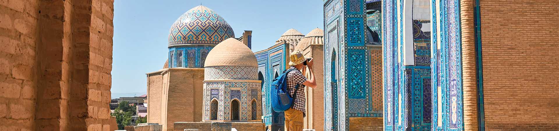 Tourist taking photograph infront of Shahi Zinda mausoleum, Samarkand