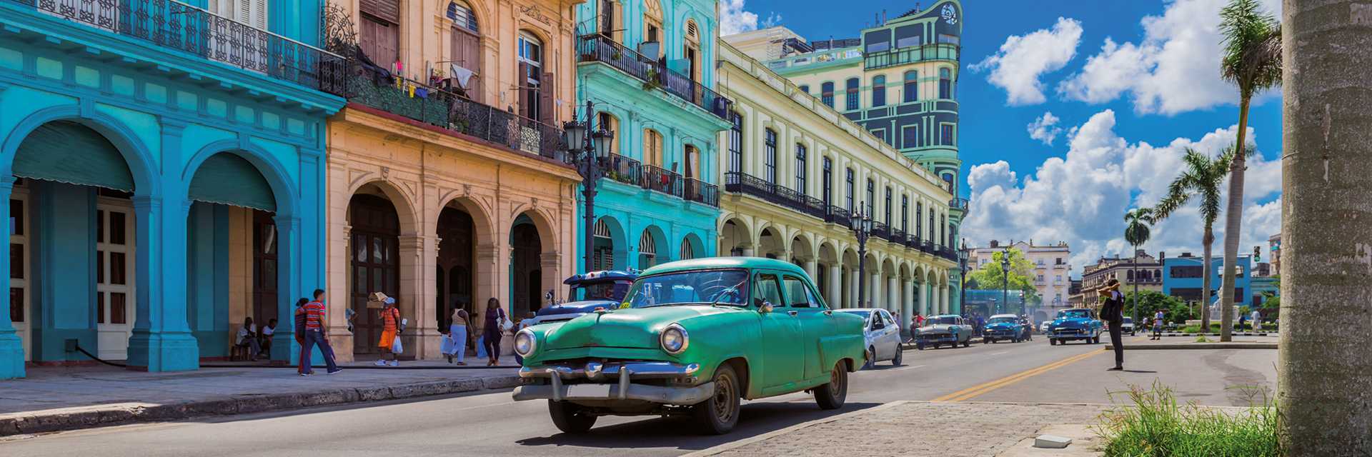 Cityscape with american green vintage car on the main street in Havana City Cuba 