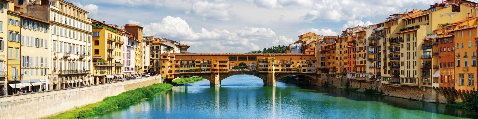 View of stone bridge Ponte Vecchio and the Arno River from the Ponte Santa Trinita in Florence, Tuscany, Italy