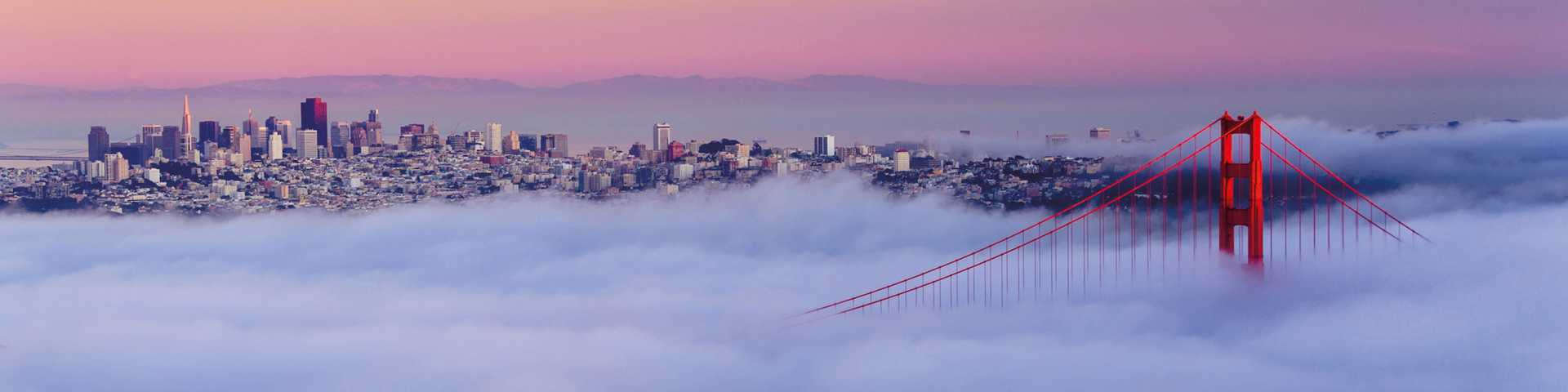 Panoramic view of famous Golden Gate Bridge seen from Baker Beach in beautiful golden evening light. San Francisco, California, USA