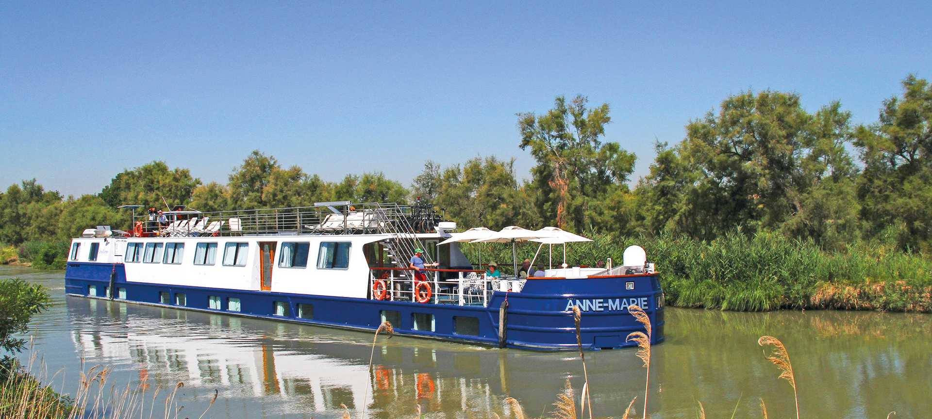 MS Anne-Marie, a river cruise ship, sails a picturesque French waterway
