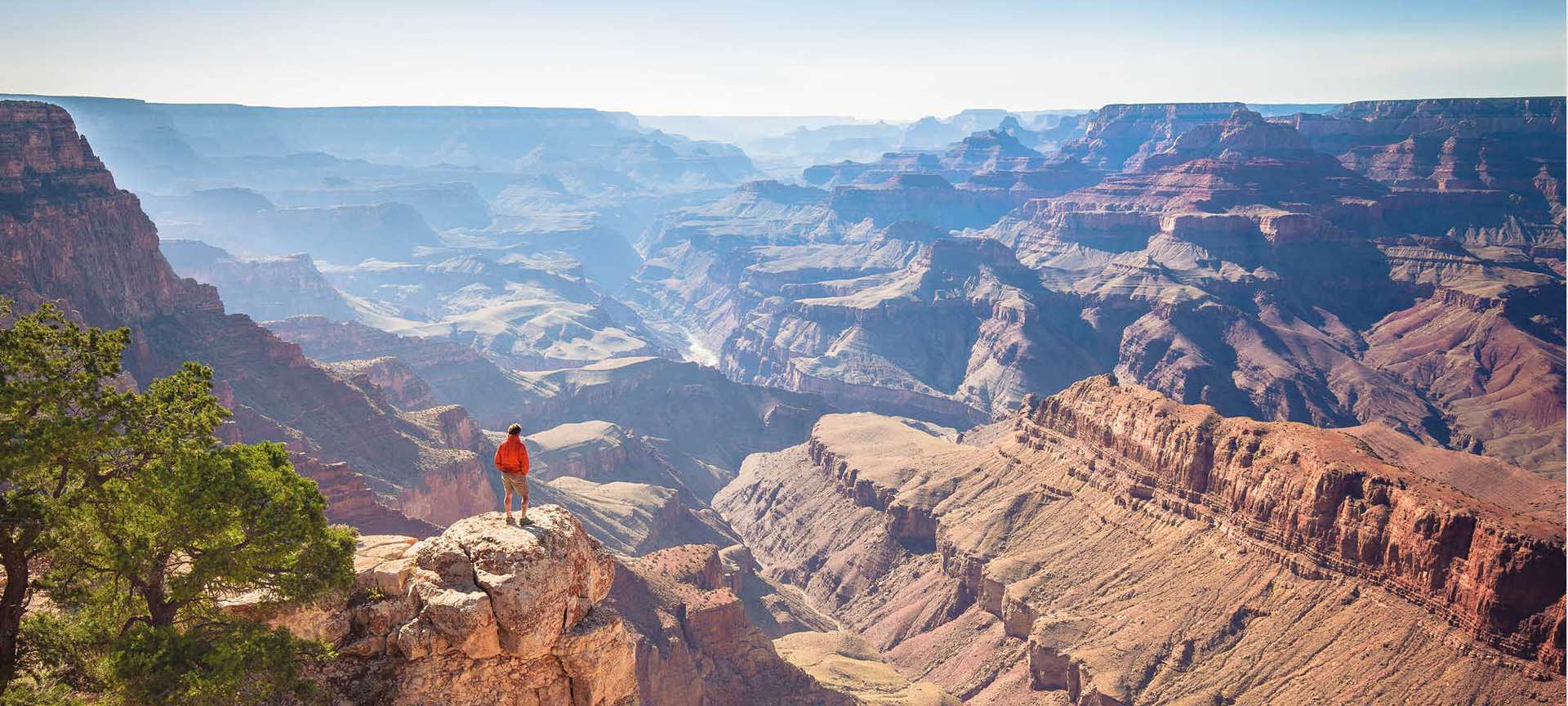 A man stands on the edge of the Grand Canyon in Arizona, USA