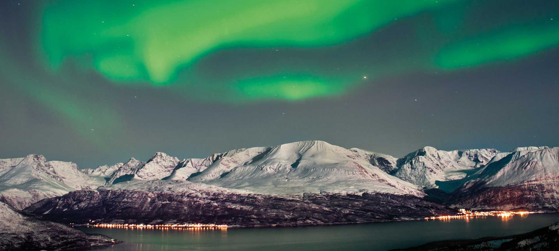 Beautiful Aurora above fjords near Skibotn, Norway