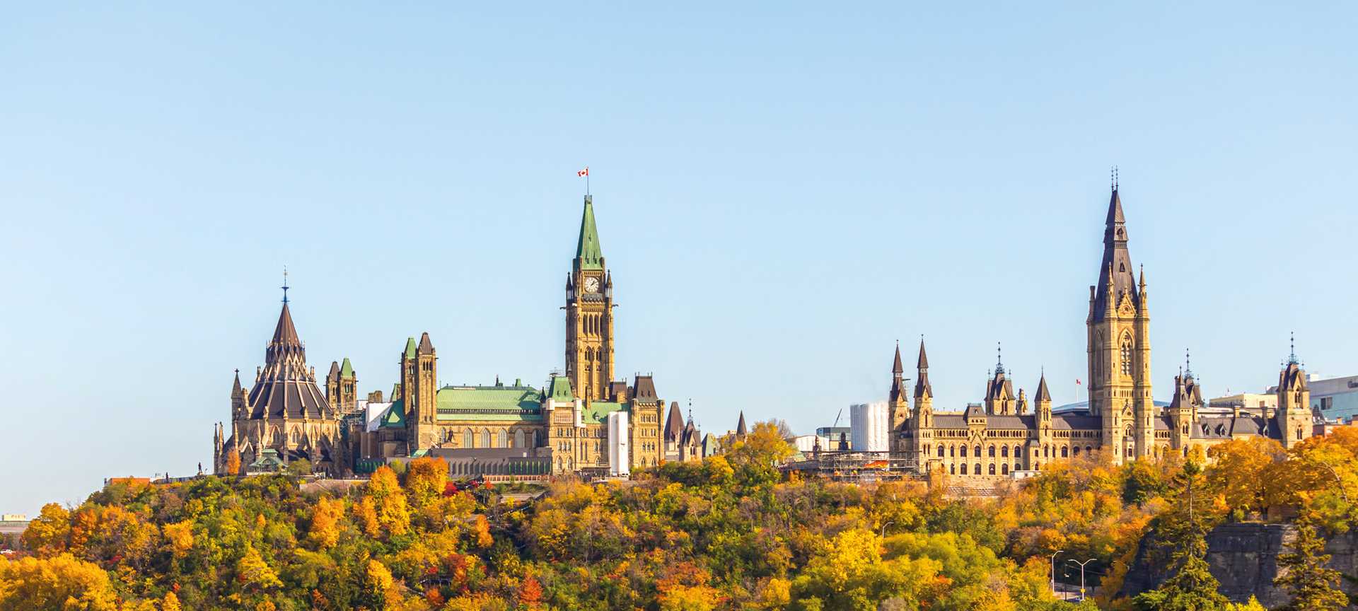 Parliament Hill in Ottawa, Canada, from the west, showing the library and Peace Tower of Centre Block and Mackenzie Tower of West Block