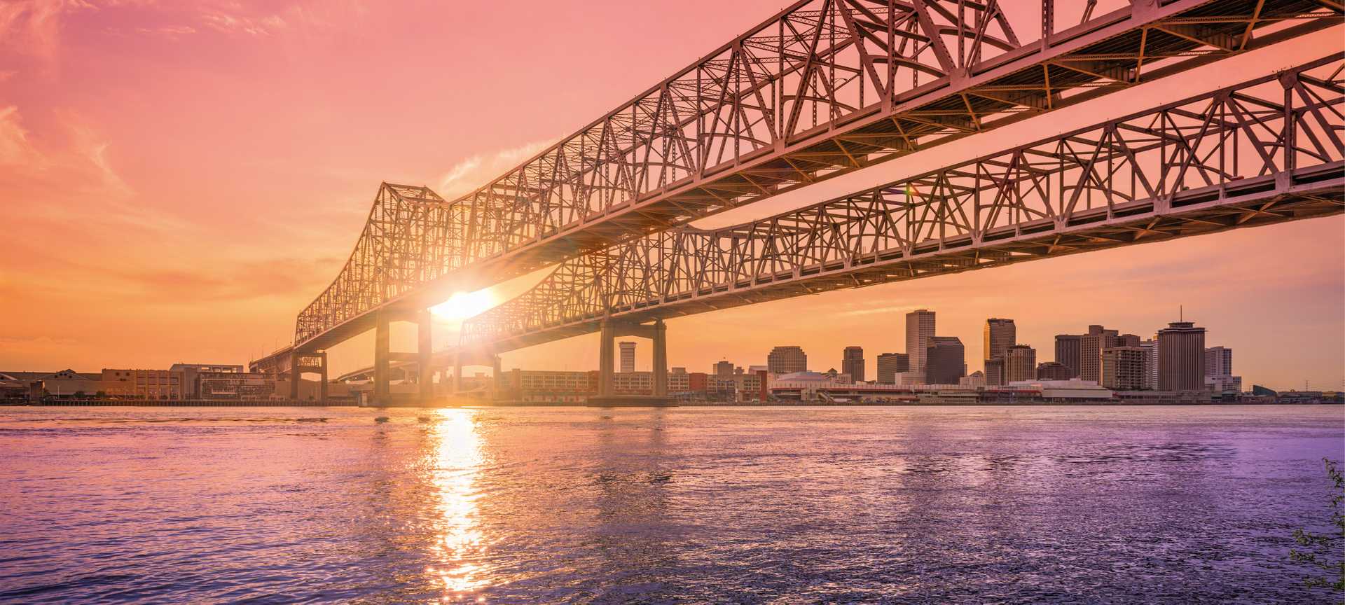 Crescent City Connection Bridge over the Mississippi River during sunset. New Orleans, Louisiana, USA