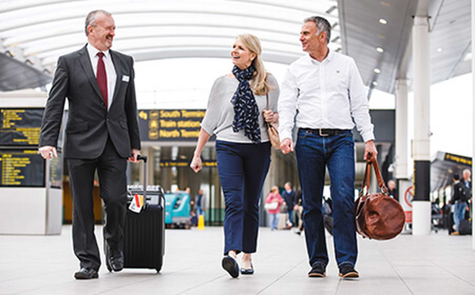 A Titan VIP driver greets a couple at the airport as they return from their Titan holiday