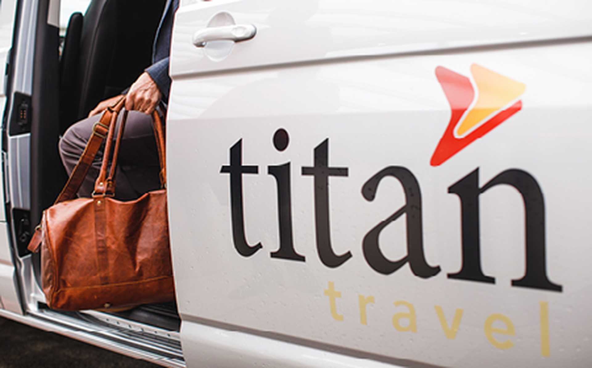A close up shot of the Titan logo on the side of the VIP transfer vehicle.