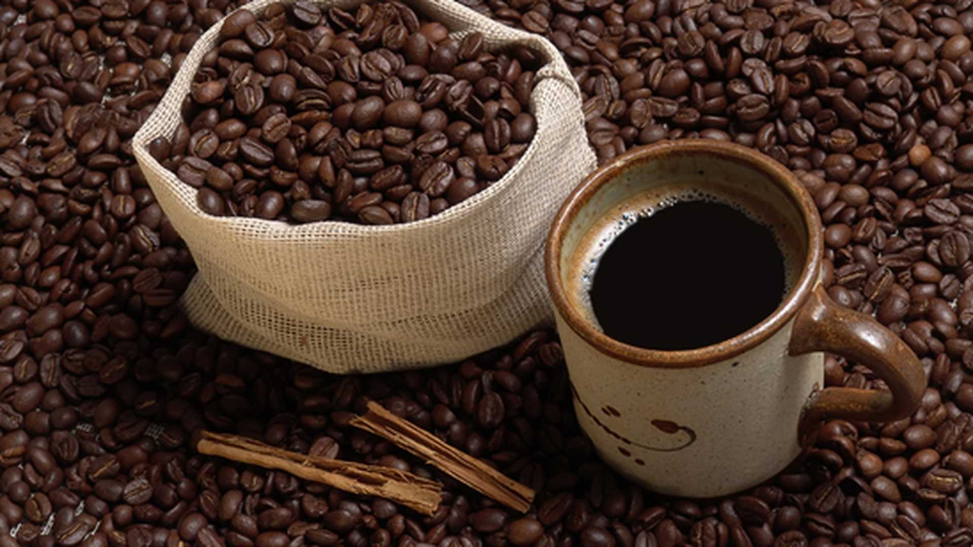 A cup of coffee and coffee beans