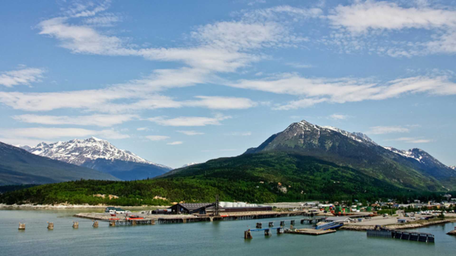 View of the water with snow-topped mountains behind in Skagway, Alaska