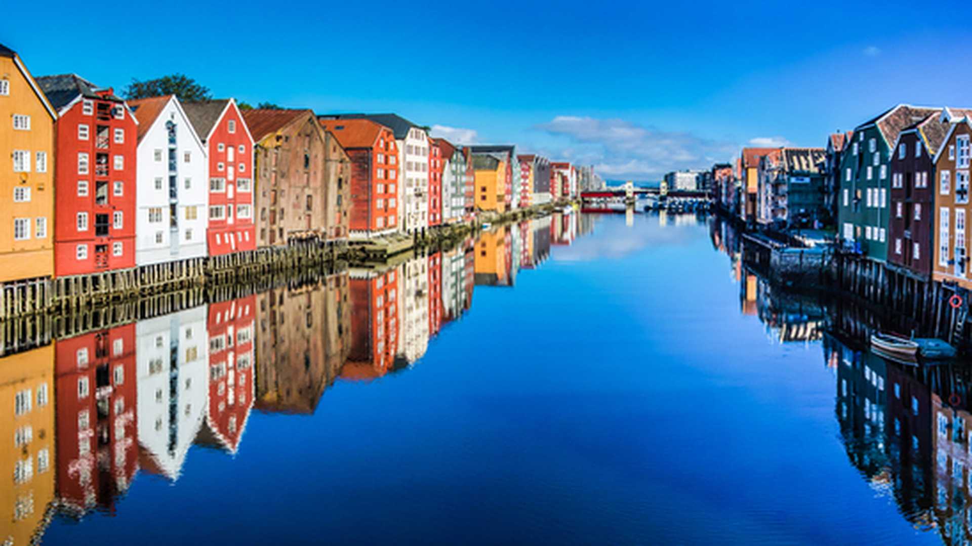 Colourful buildings reflected in the water in Trondheim, Norway