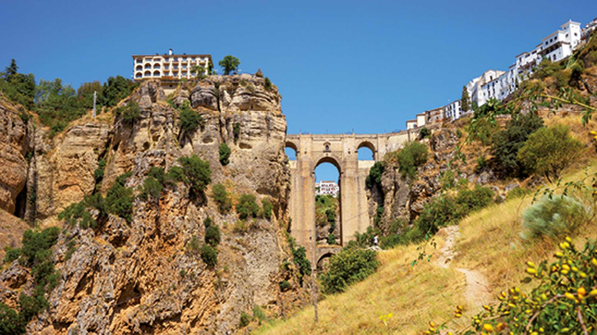 Beautiful view of historic roman bridge connecting two parts of Ronda, Spain