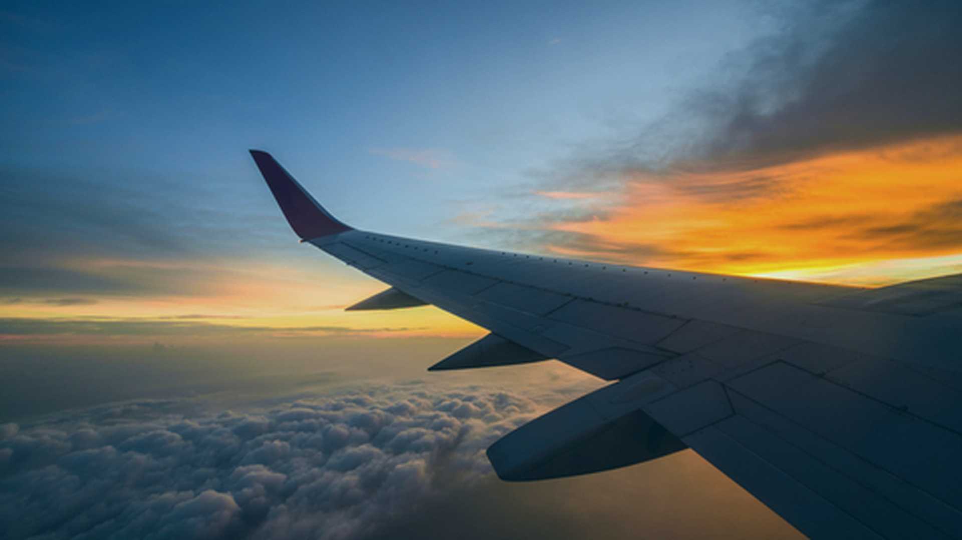 Airplane wing at sunset