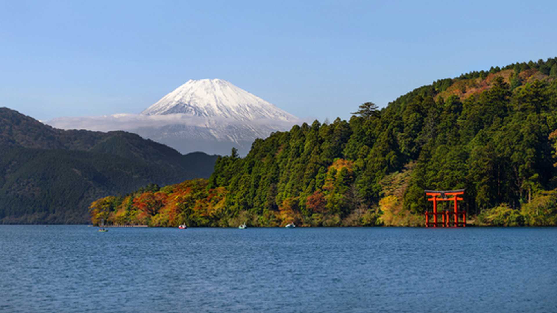 Mt. Fuji and a big red Torii on the Ashinoko Lake under blue clear sky. View from Hakone in Japan.