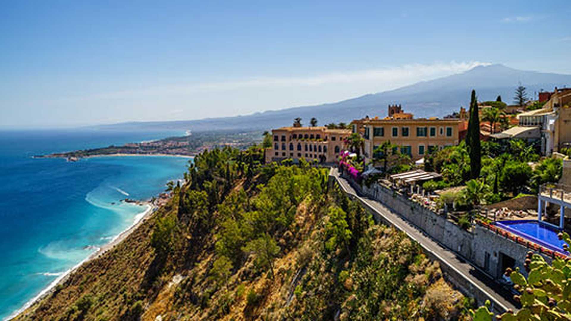 Taormina with Mount Etna extending over the the Giardini-Naxos bay of the Ionian Sea, Sicily