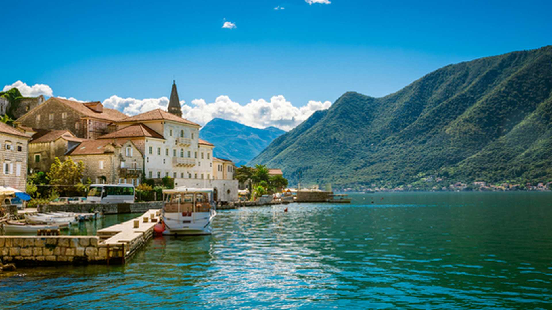 Harbour in Perast at Boka Kotor bay, Montenegro, with forested hills behind