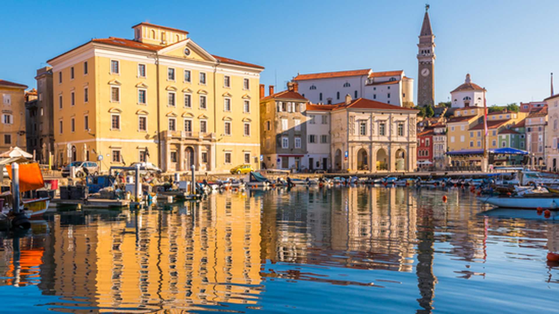 Venetian port and Tartini Square reflected in the water in Piran, Slovenia