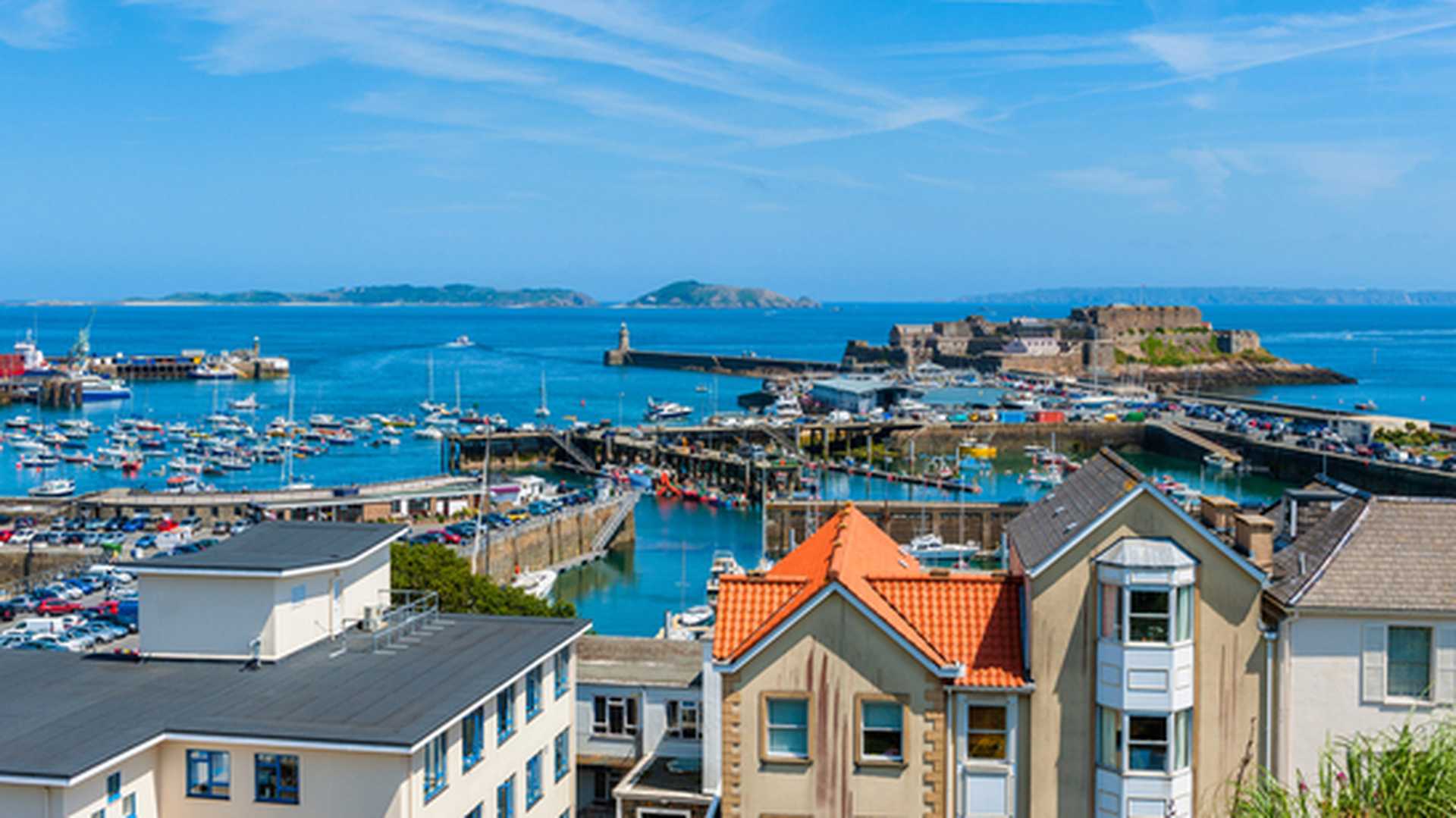 View over the harbour of Saint Peter Port, Guernsey, with the Islands of Herm and Sark in the distance
