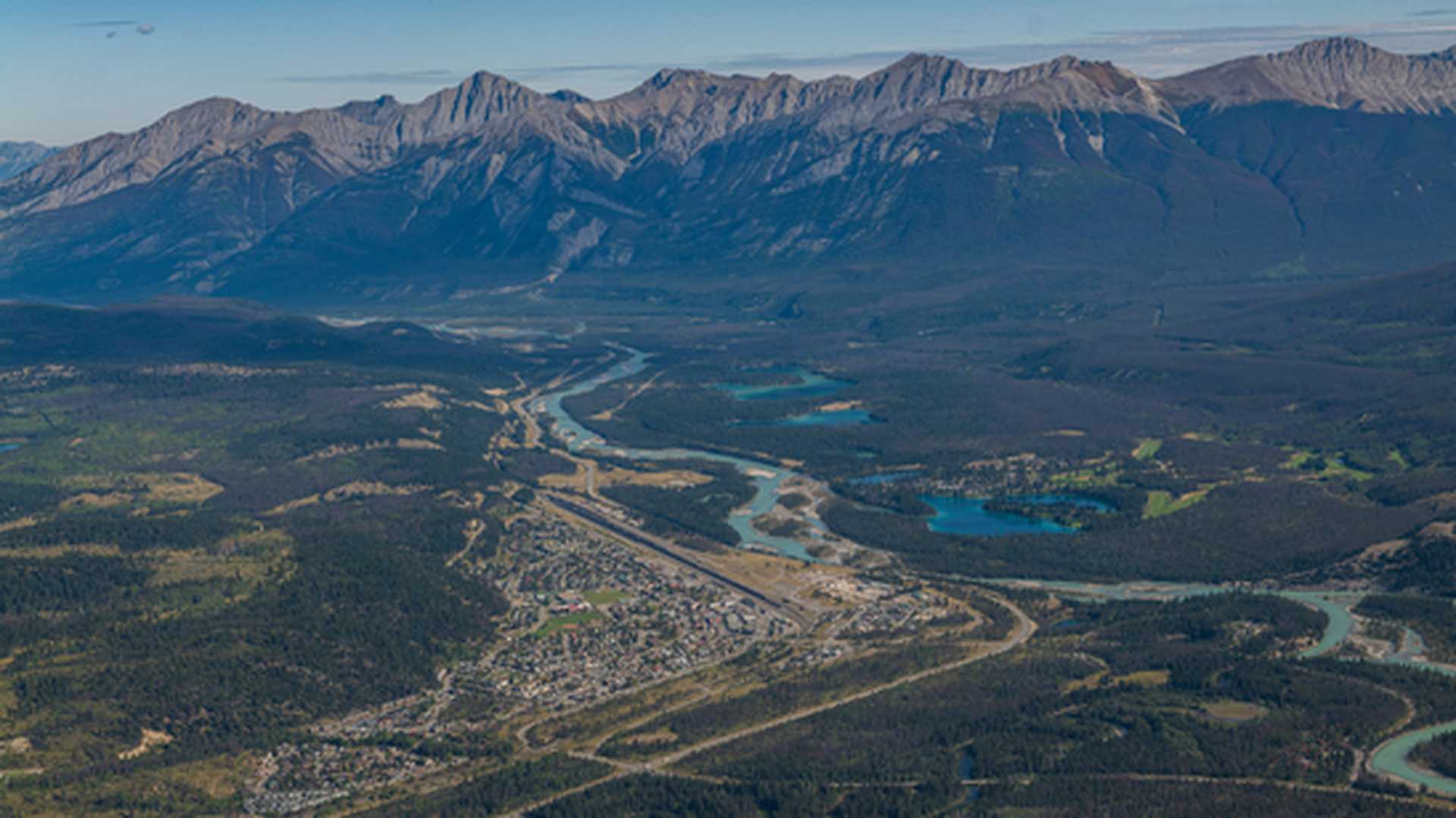 Town of Jasper Alberta, Canada from an aerial view and mountains and lakes in the distance