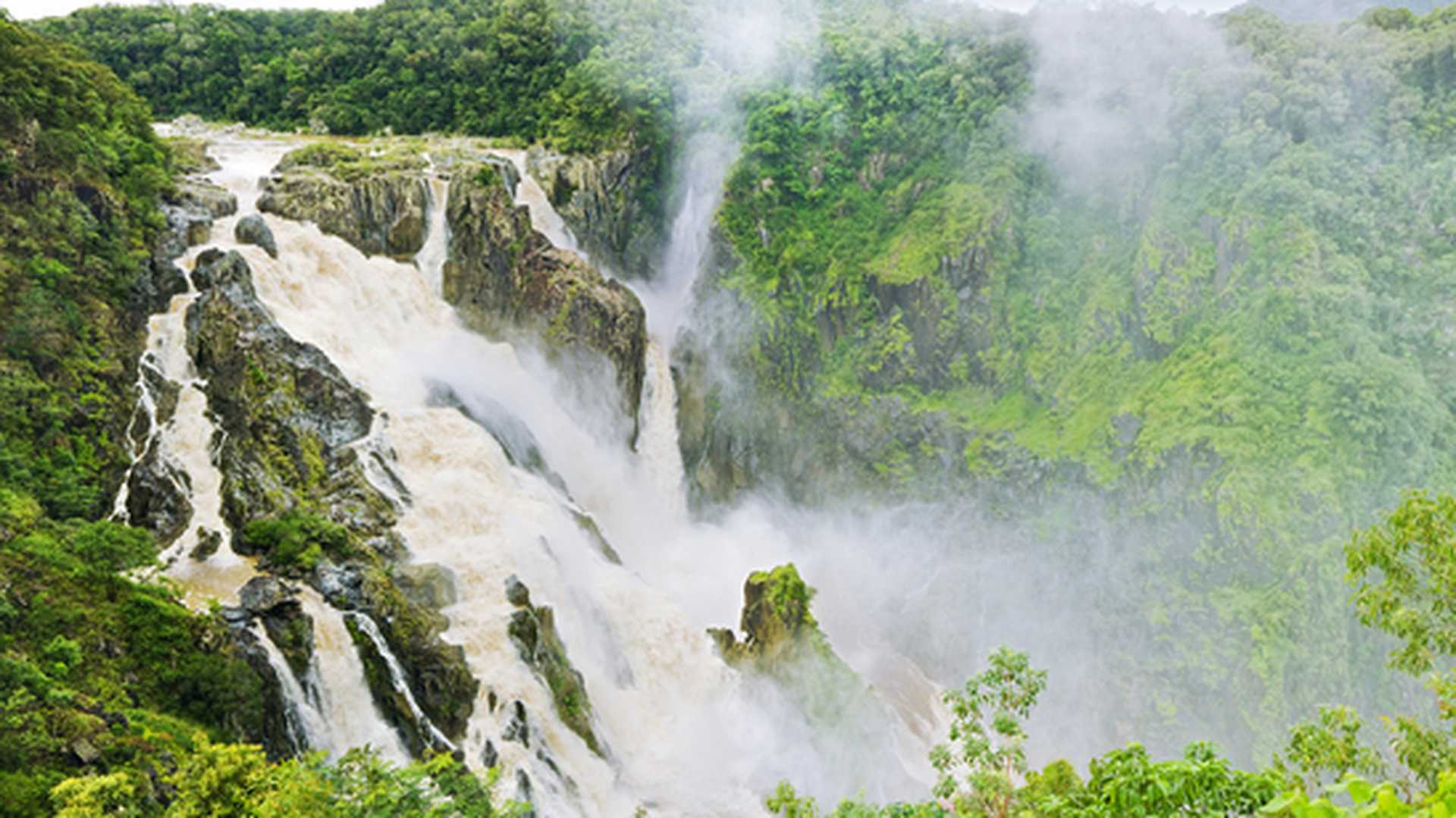 The Barron Falls - massive waterfall in Kuranda, Queensland, Australia surrounded by tropical rainforest