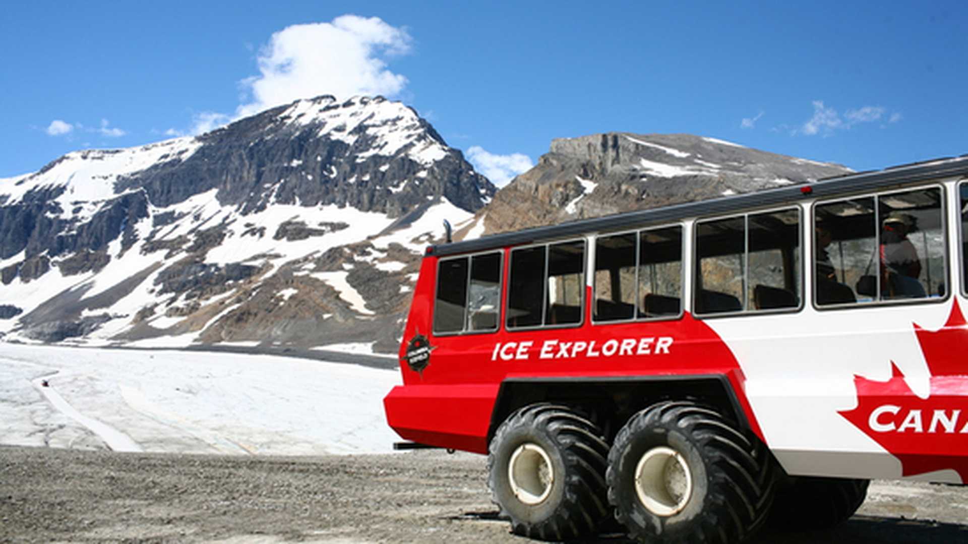 An Ice Explorer vehicle waits next to Athabasca Glacier in Jasper National Park, Canada