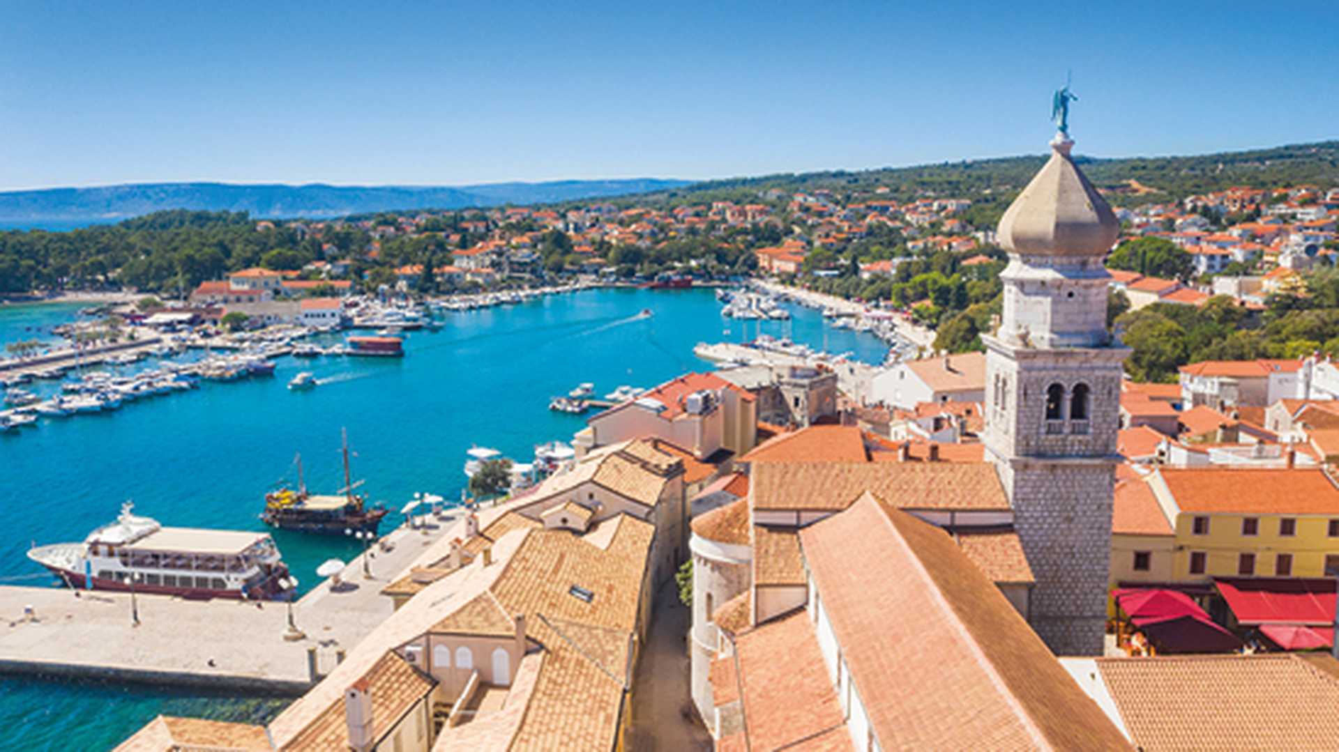 Aerial view of the old town of Krk in Croatia, cathedral tower and marina