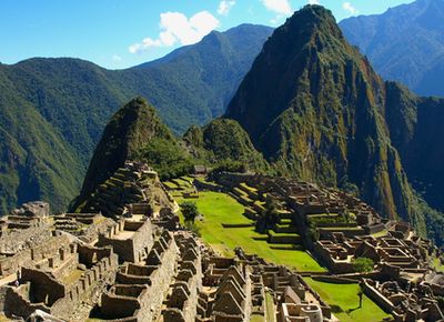 View across the ancient Inca city of Machu Picchu, with forest-cloaked mountains surrounding