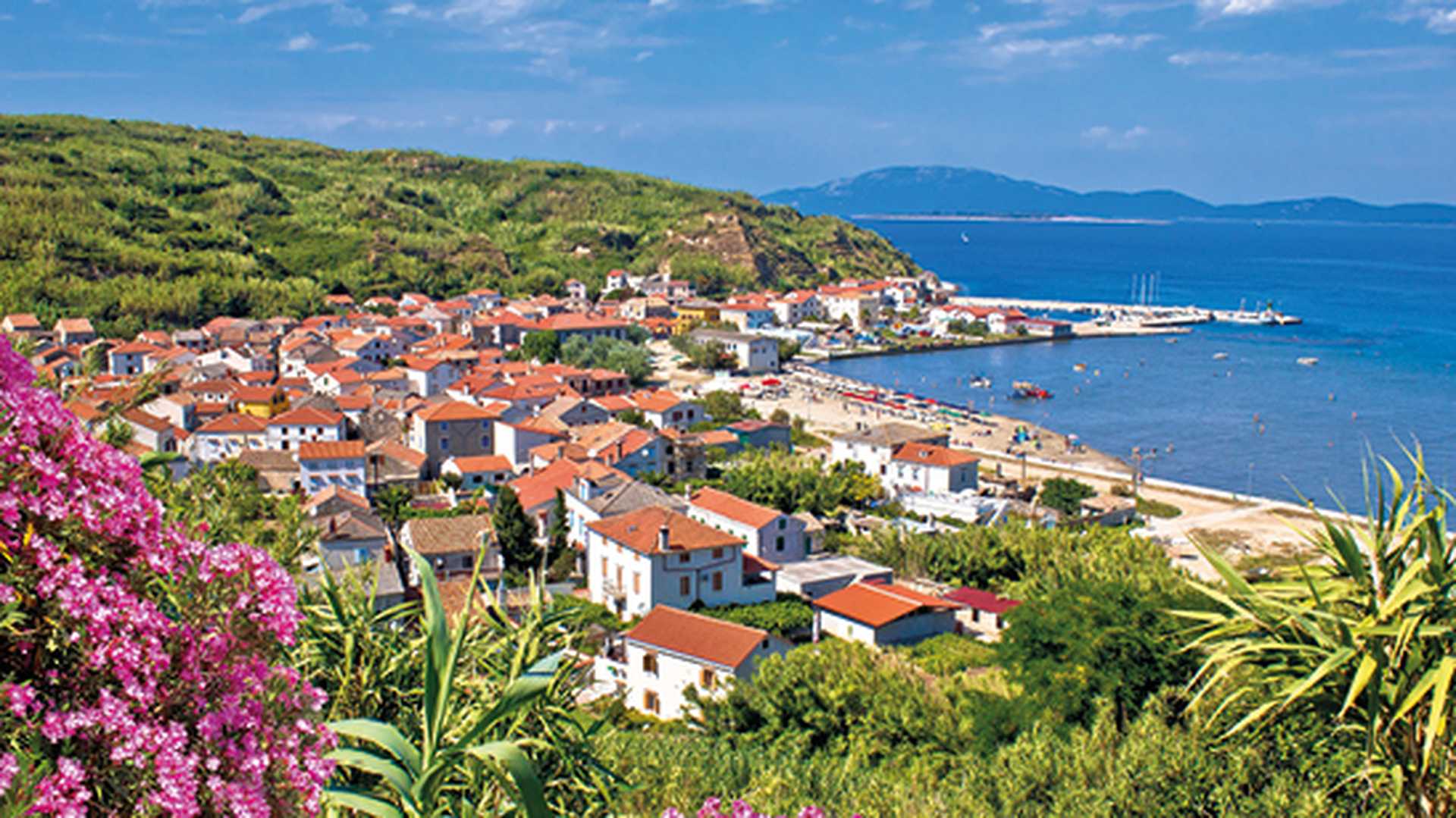 View over island of Susak with orange roofed houses and sandy beaches, Croatia