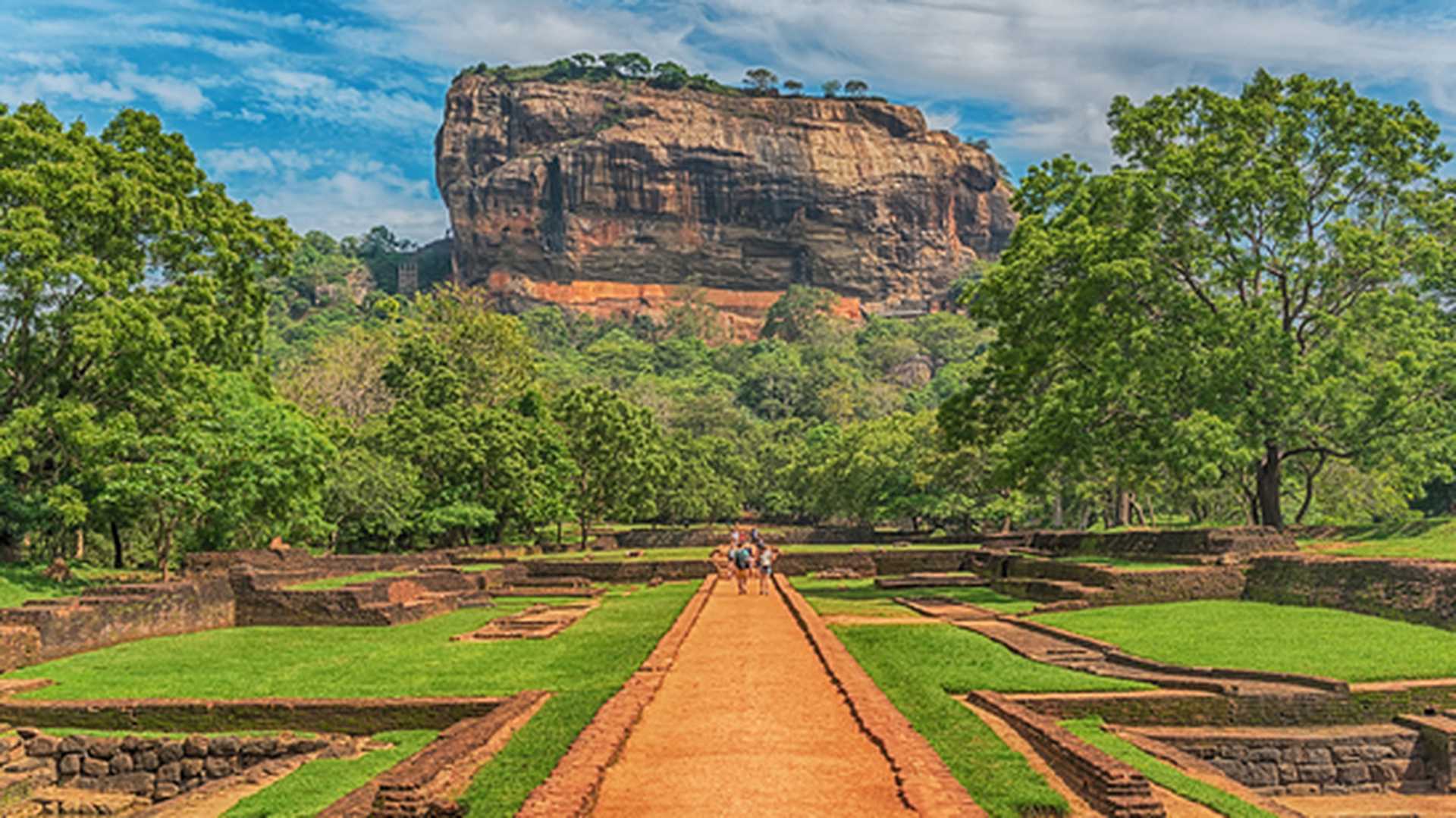 Sri Lanka: beautiful ancient Lion Rock fortress in Sigiriya or Sinhagiri, located near the town of Dambulla, a famous Sri Lankan landmark. The Gardens of Sigiriya in the foreground.