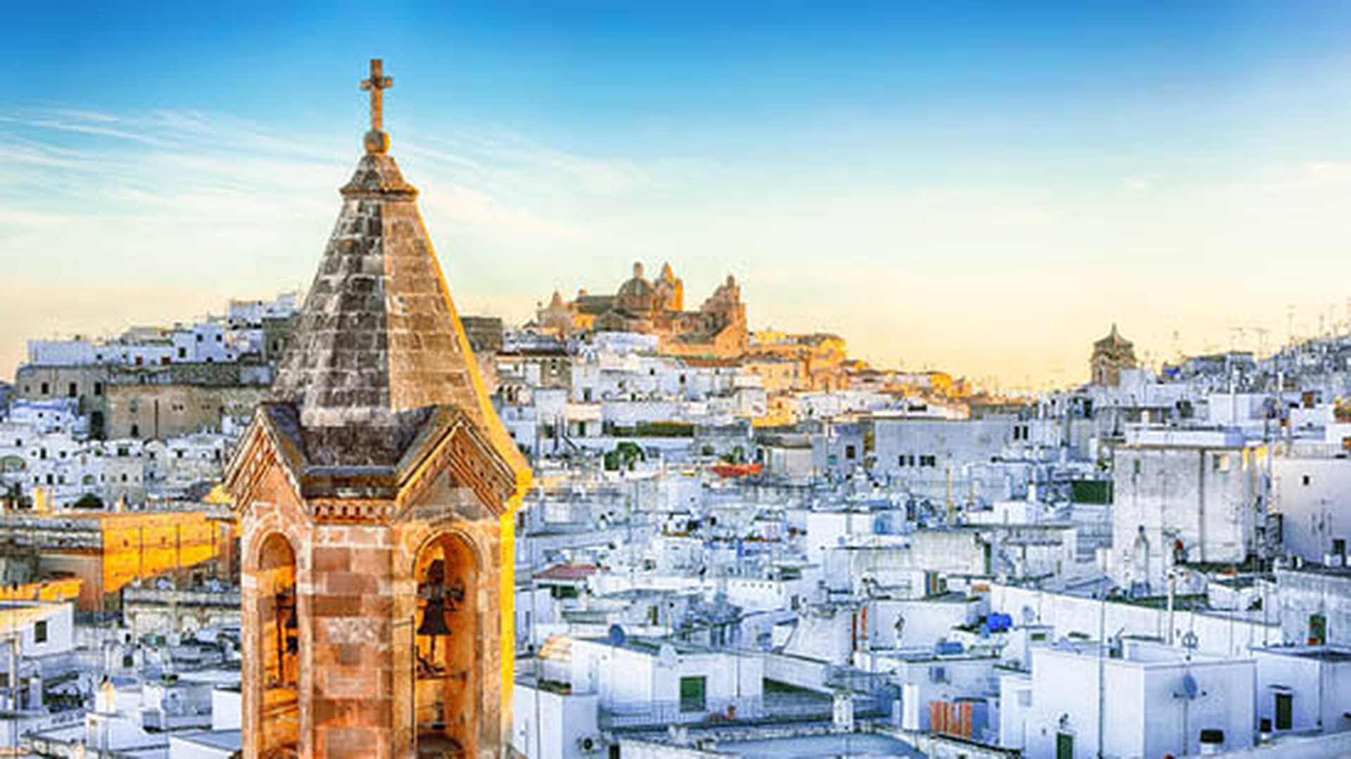View of old town white town Ostuni and cathedral at sunrise, Apulia, Italy