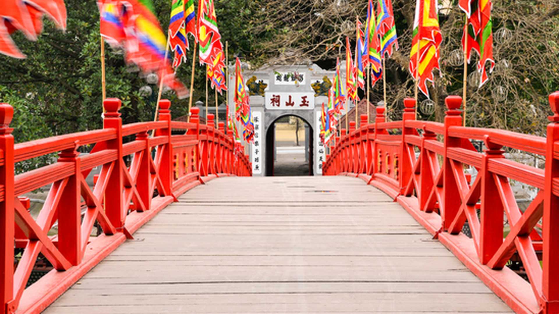 Red wooden Huc Bridge from the Ngoc Son Temple in Hanoi Vietnam leading to the exit door.
