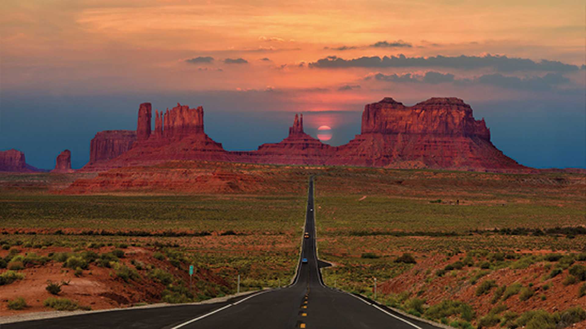 Scenic highway in Monument Valley Tribal Park in Arizona-Utah border, U.S.A. at sunset.