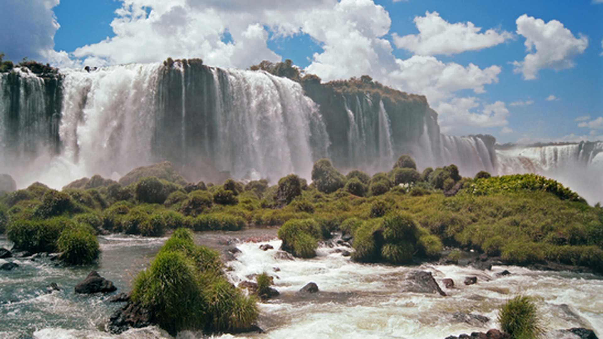 Panorama of Iguazu Falls on a sunny day 