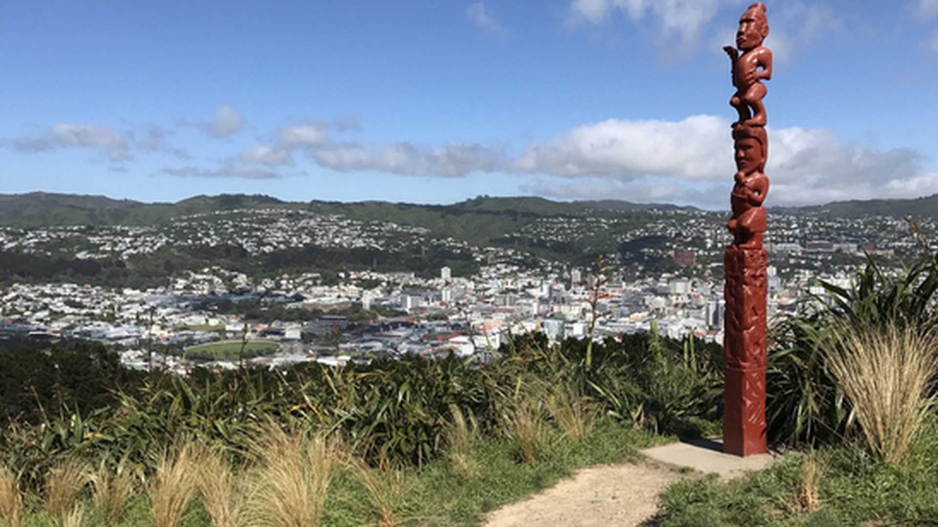 A Maori pouwhenua (a traditional carved wooden post) stands atop Mount Victoria in Wellington, New Zealand