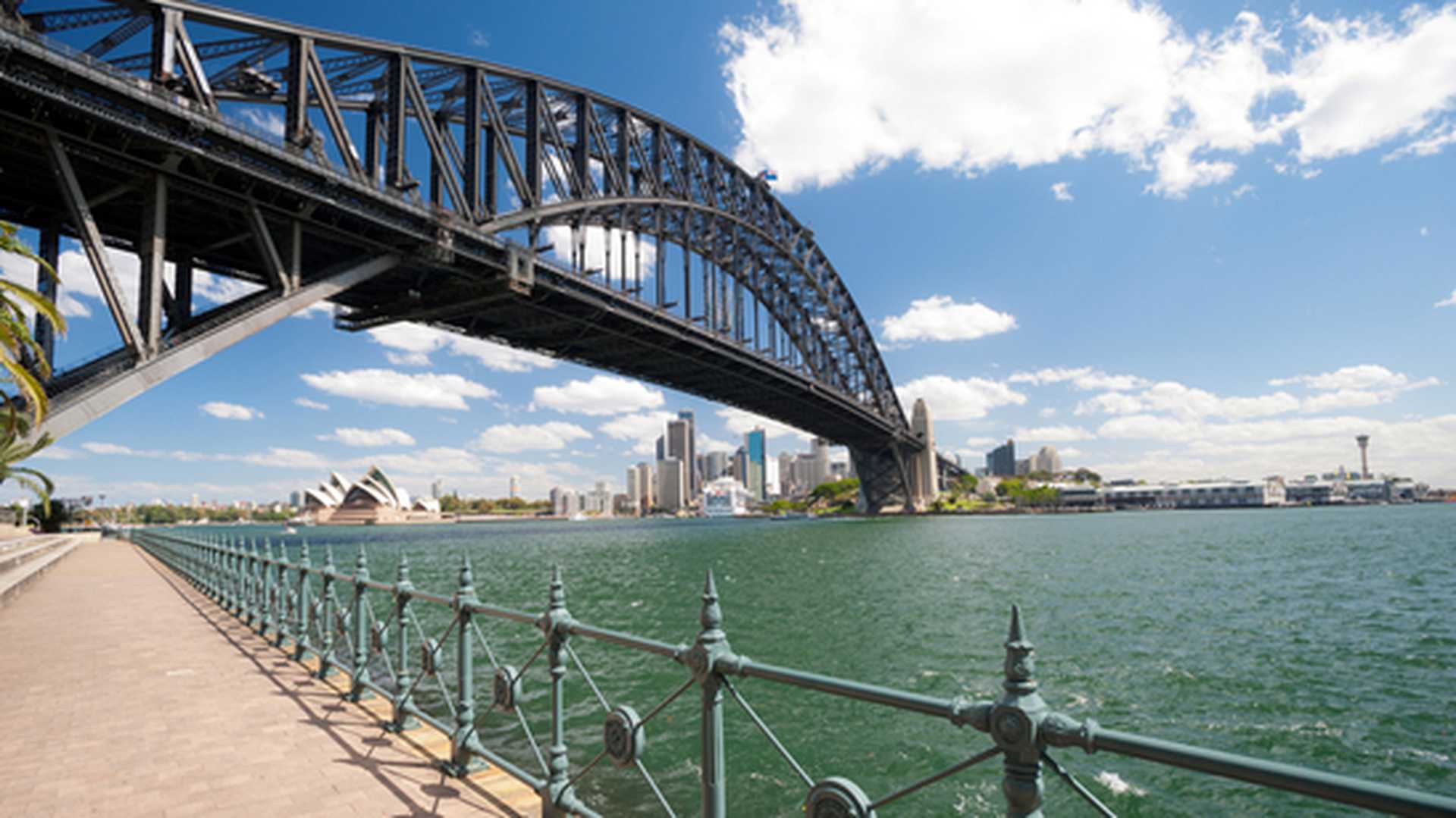 View from beneath Sydney Harbour Bridge looking across the water to the Opera House and CBD skyline